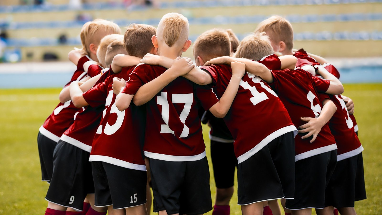 kids football team discussing strategy