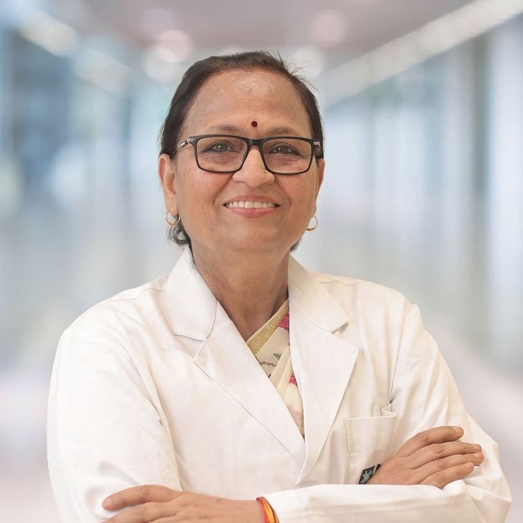 dr sushma bhatnagar posing in her lab coat and showing her gorgeous smile